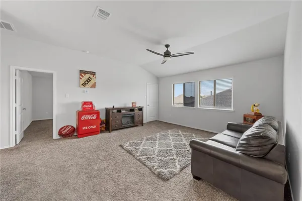 a view of an empty room with a ceiling fan and a window