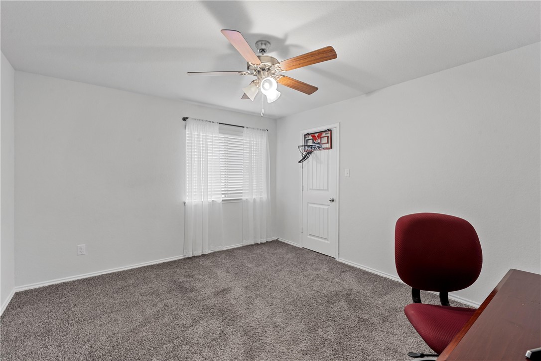 11208 Echo Drive Waco, TX 76708 - Photo 26 of 34 a view of an empty room with a ceiling fan and a window
