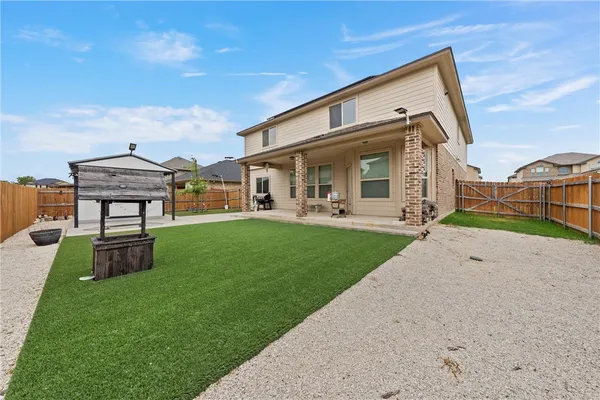 a backyard of a house with a garage