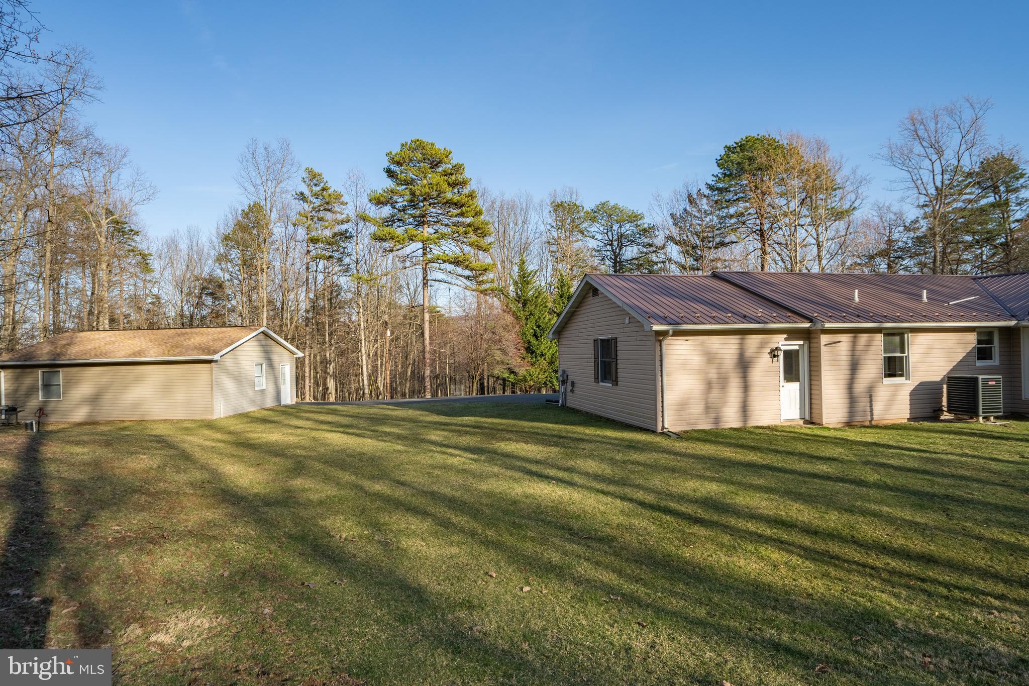 4475 Milo School Road Great Cacapon, WV 25422 - Photo 54 of 63 a front view of a house with a yard
