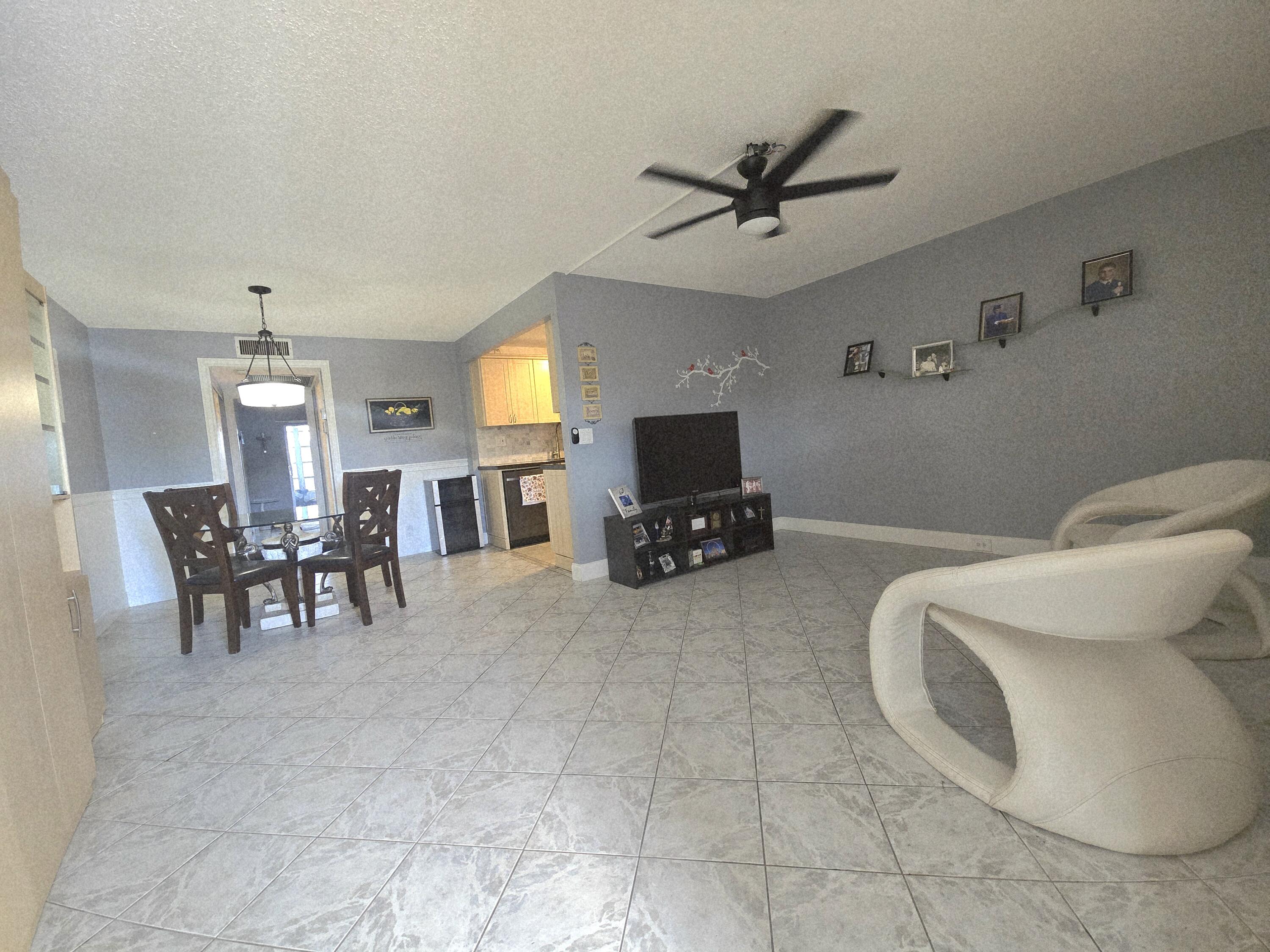 2010 Westbury F, Unit 2010 Deerfield Beach, FL 33442 - Photo 11 of 28 a living room with furniture and a flat screen tv