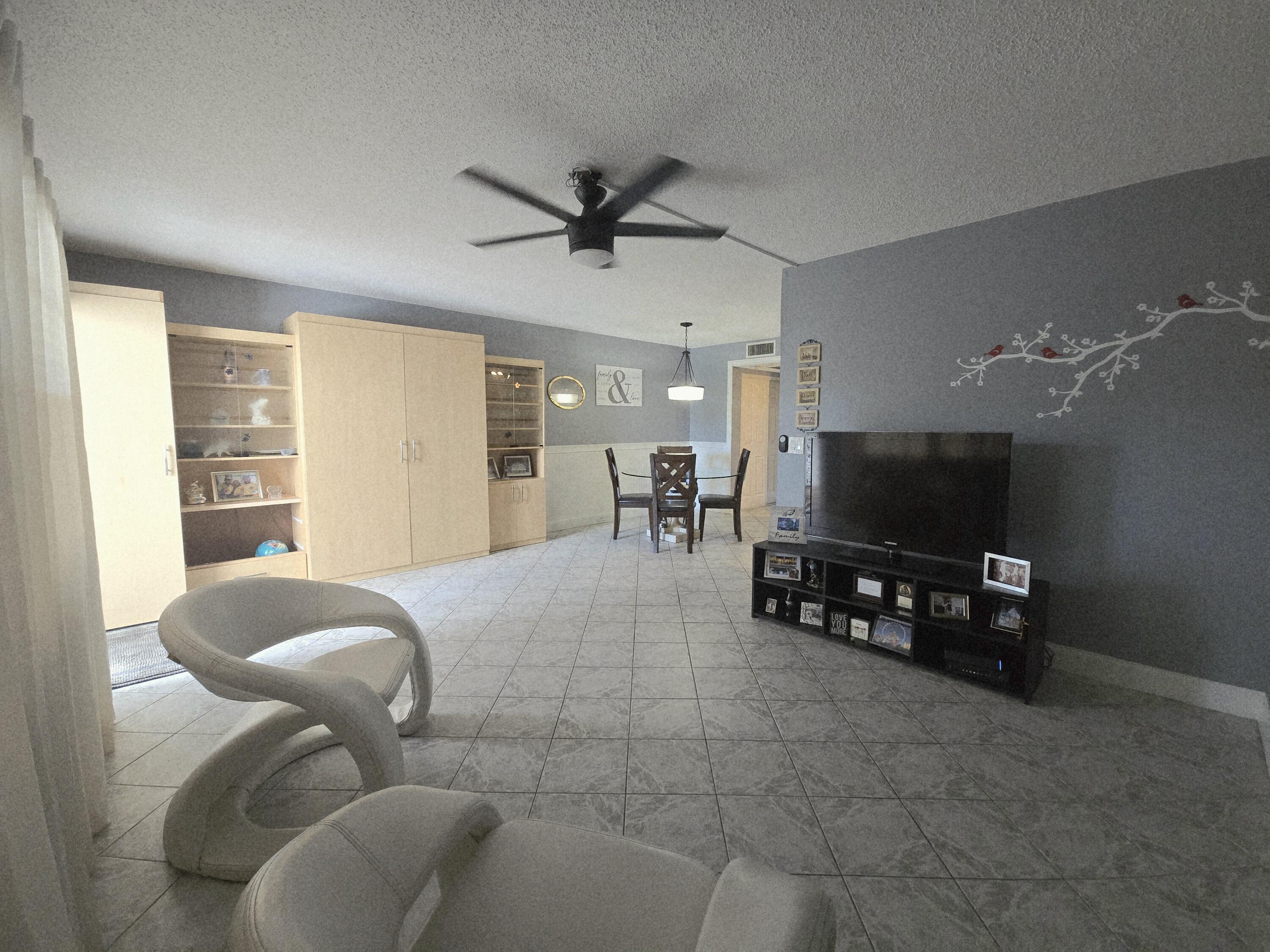 2010 Westbury F, Unit 2010 Deerfield Beach, FL 33442 - Photo 12 of 28 a living room with furniture and a flat screen tv
