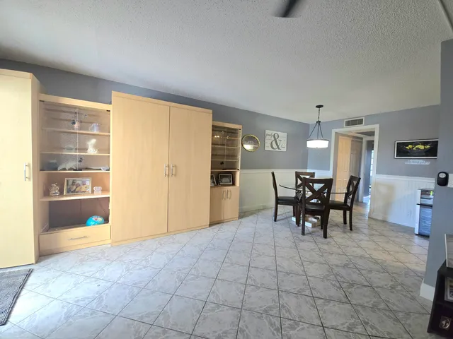 a view of a livingroom with furniture and with a table chair