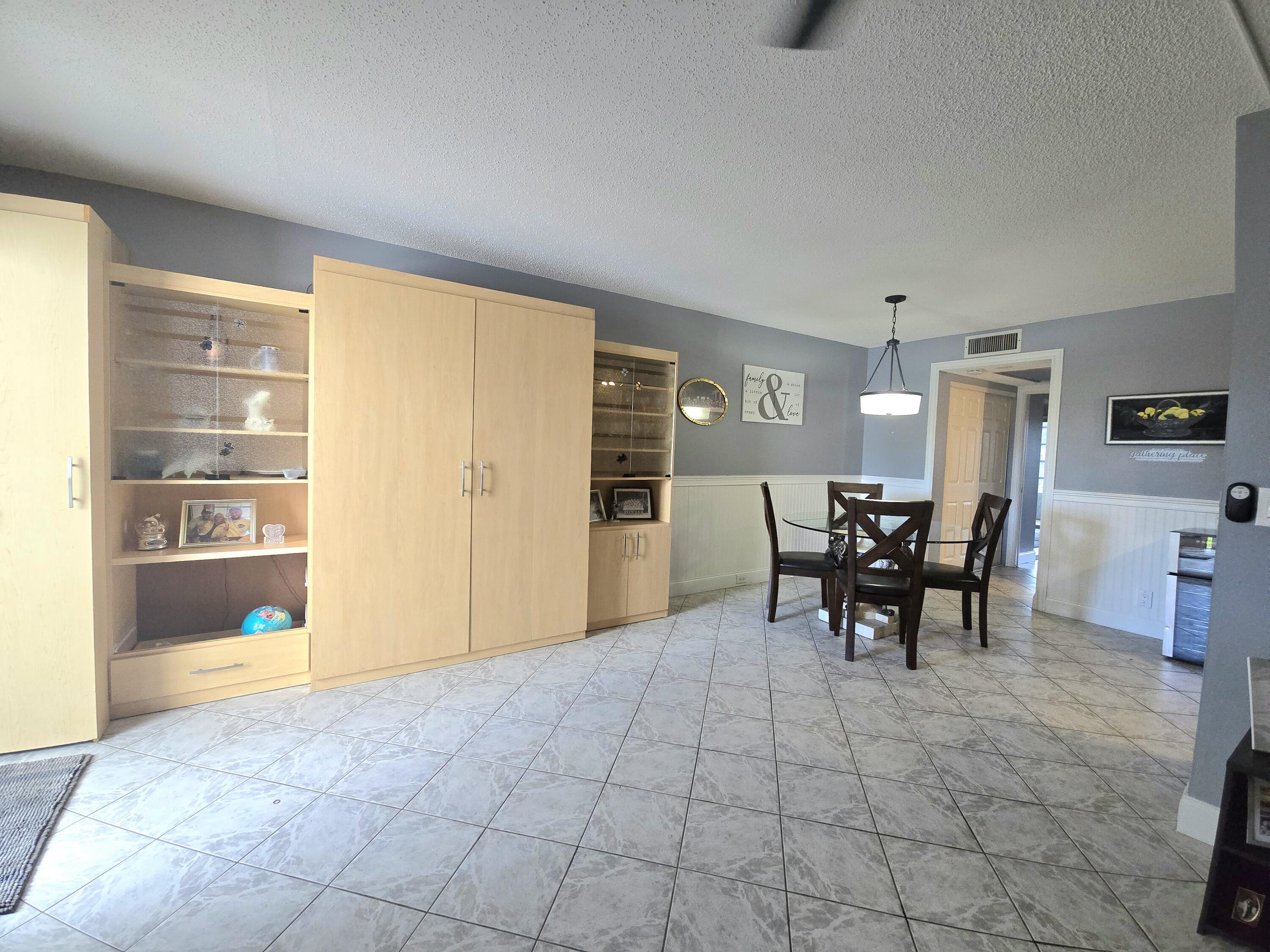 2010 Westbury F, Unit 2010 Deerfield Beach, FL 33442 - Photo 13 of 28 a view of a livingroom with furniture and with a table chair