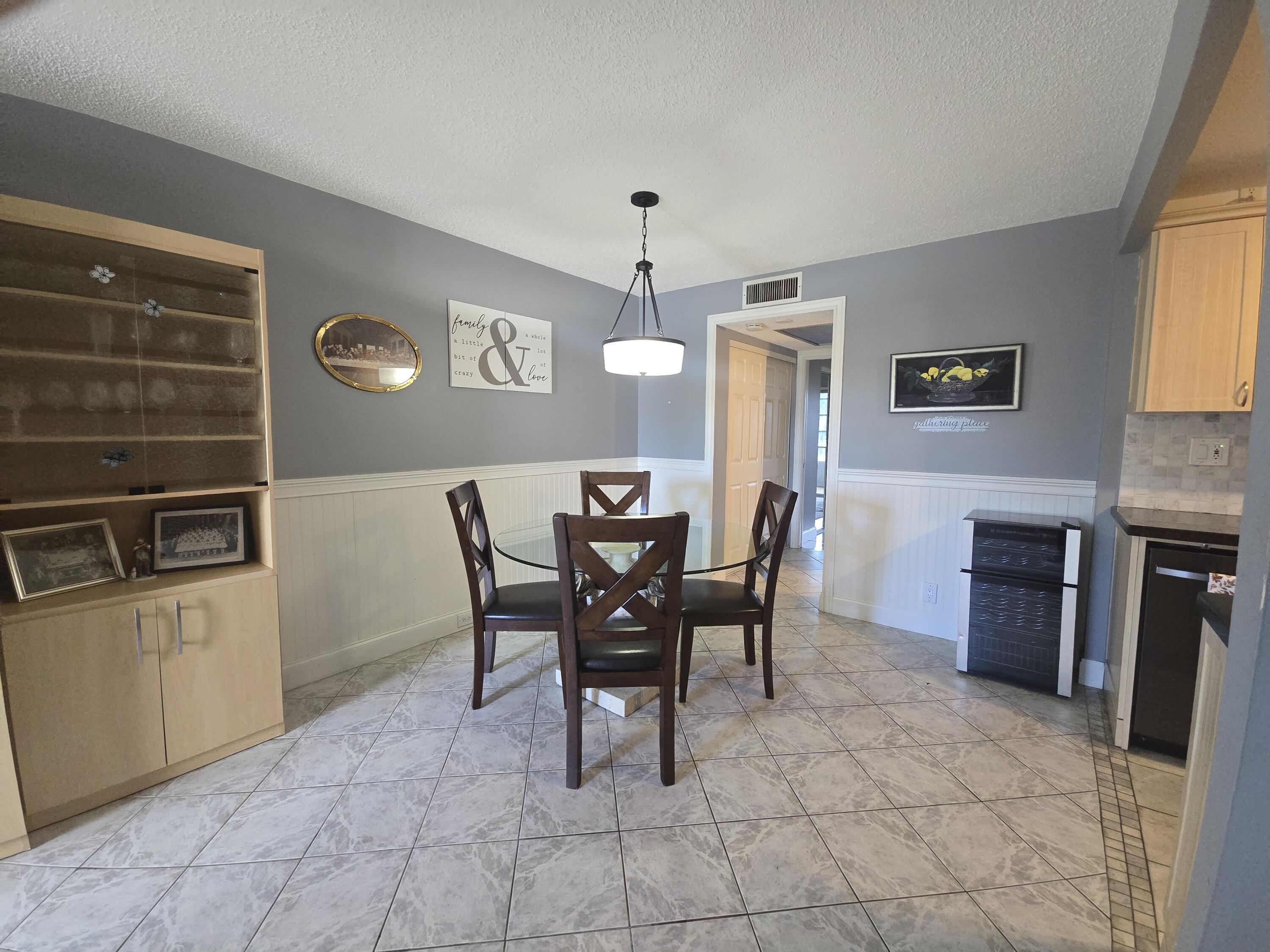 2010 Westbury F, Unit 2010 Deerfield Beach, FL 33442 - Photo 14 of 28 a view of a dining room with furniture