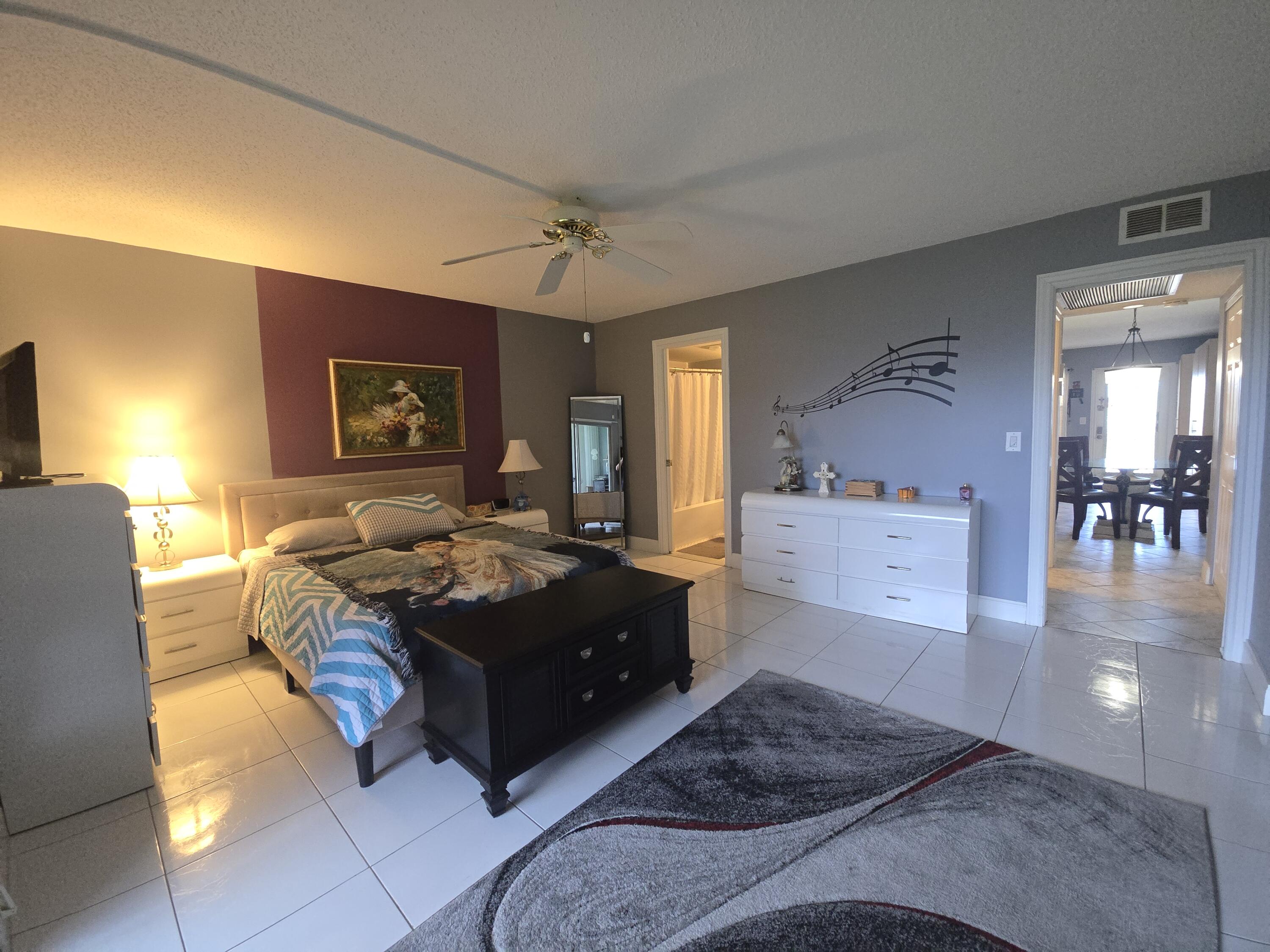 2010 Westbury F, Unit 2010 Deerfield Beach, FL 33442 - Photo 21 of 28 a living room with furniture and a flat screen tv