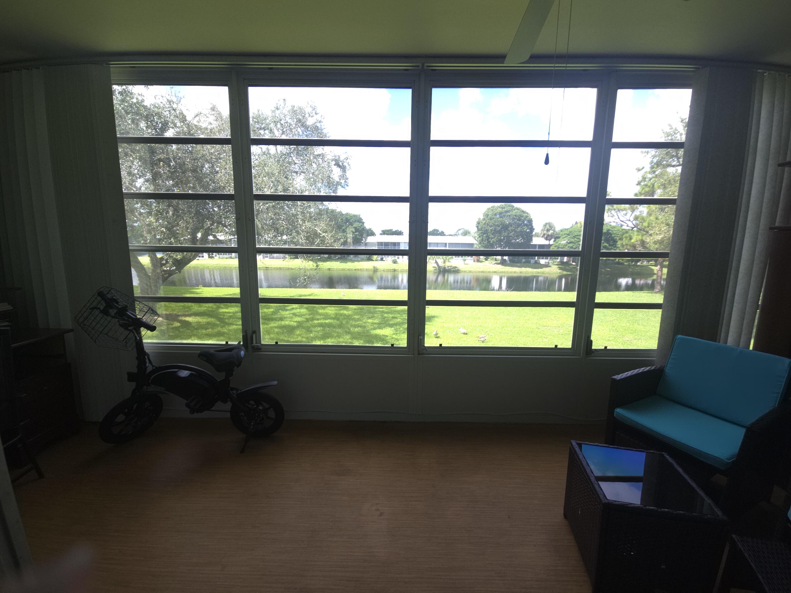 2010 Westbury F, Unit 2010 Deerfield Beach, FL 33442 - Photo 25 of 28 a room with furniture and a window