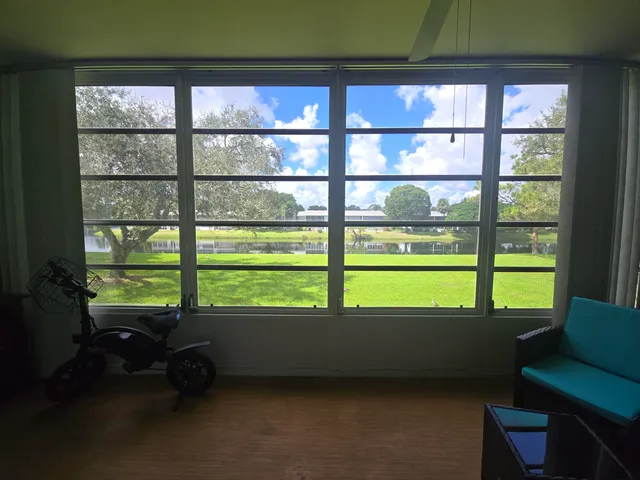 a room with pool table and windows
