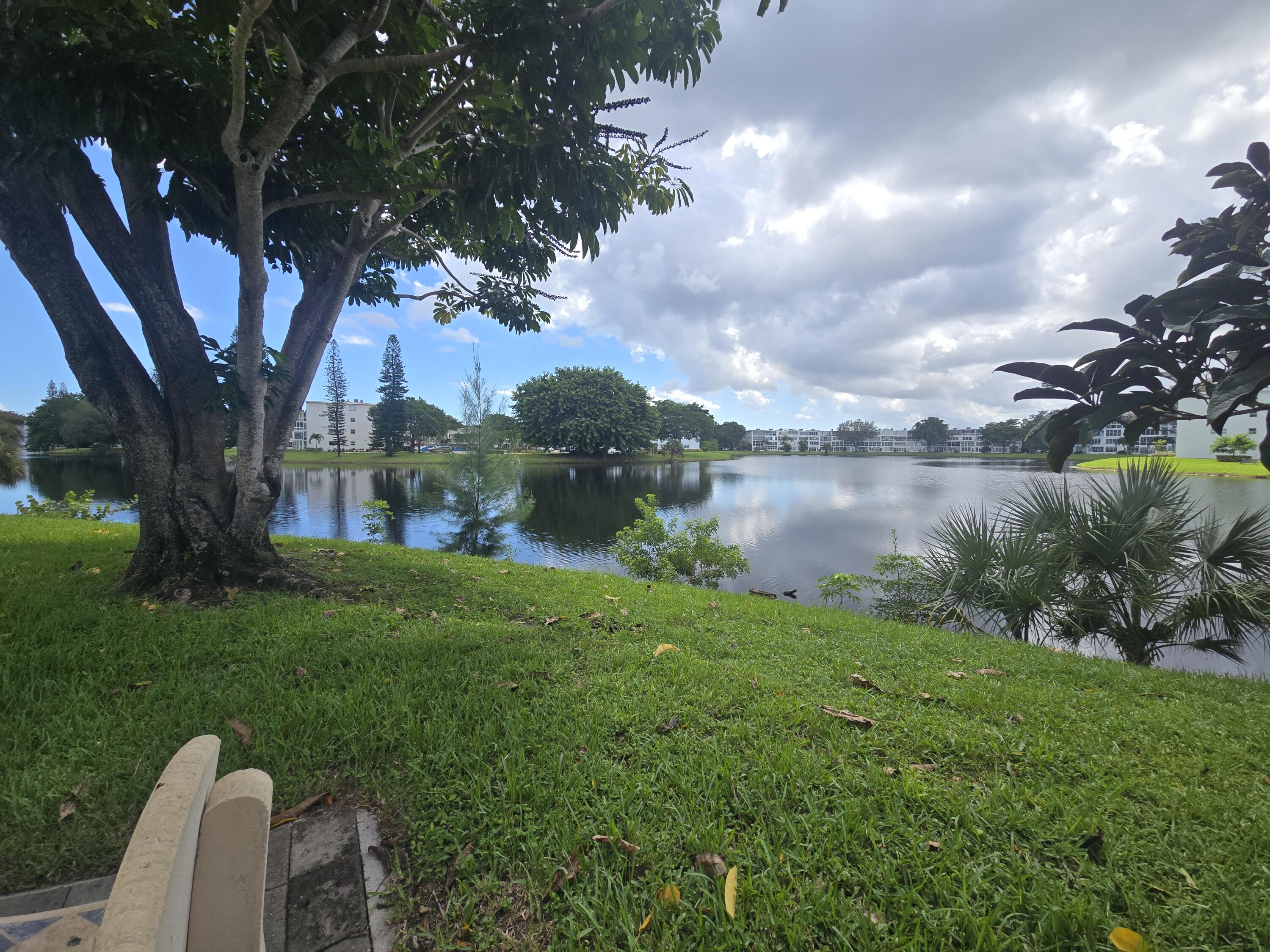2010 Westbury F, Unit 2010 Deerfield Beach, FL 33442 - Photo 6 of 28 a view of a lake with a yard