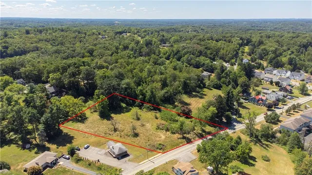 an aerial view of a forest with houses