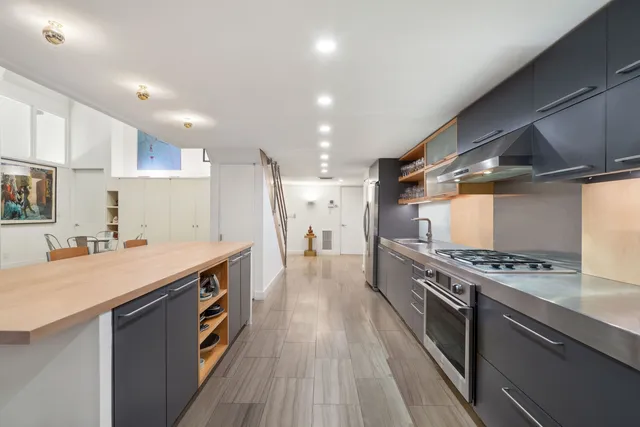 a kitchen with stainless steel appliances granite countertop a stove and a refrigerator