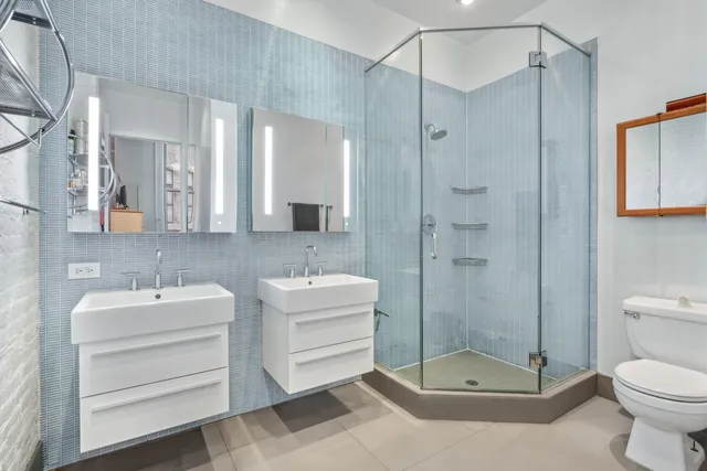 a bathroom with a toilet a sink and shower