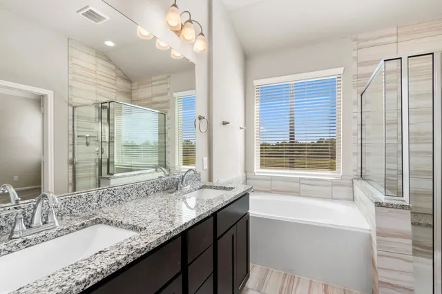 a bathroom with a bathtub and shower