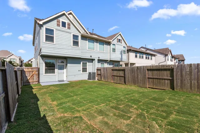 a view of a house with wooden floor and a yard with plants
