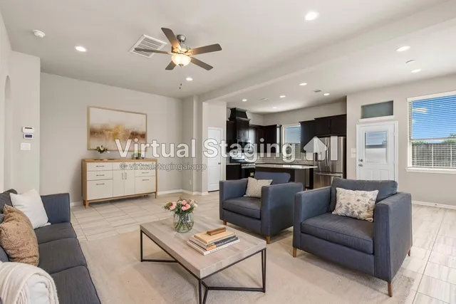 a living room with furniture and kitchen view