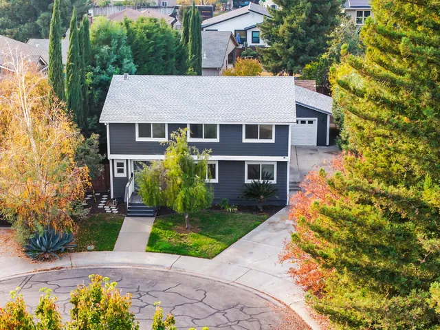 a view of a house with a yard and plants