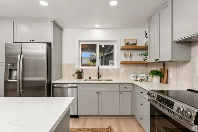 a kitchen with a sink a stove and refrigerator