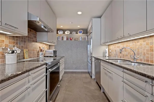 a kitchen with stainless steel appliances granite countertop counter space a sink and cabinets