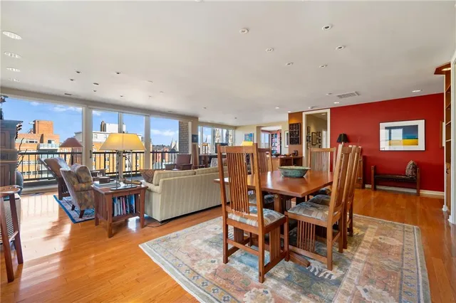 a dining room with furniture and wooden floor