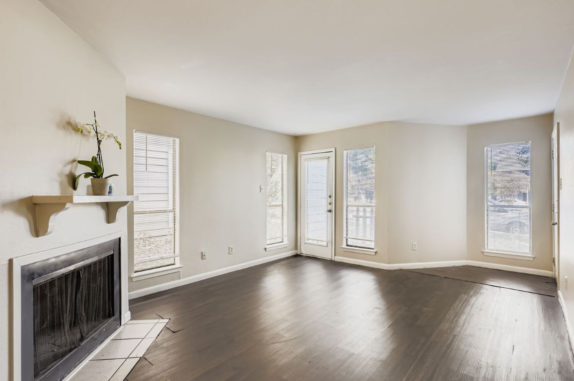 2005 West Loop, Unit A Austin, TX 78758 - Photo 1 of 11 a view of an empty room with a fireplace and a window