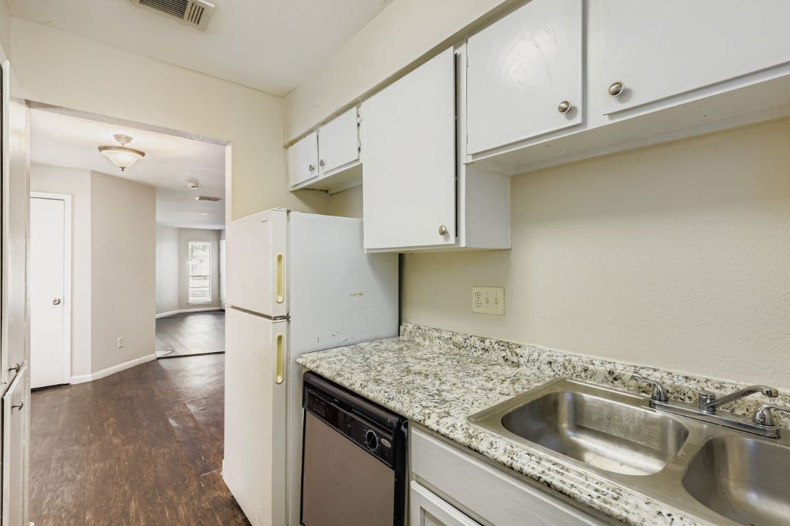 2005 West Loop, Unit A Austin, TX 78758 - Photo 5 of 11 a kitchen with a sink and refrigerator
