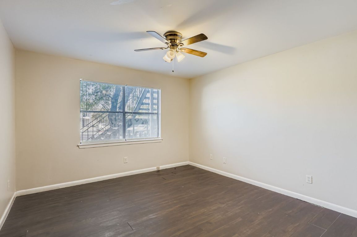 2005 West Loop, Unit A Austin, TX 78758 - Photo 6 of 11 an view of an empty room with wooden floor and a window