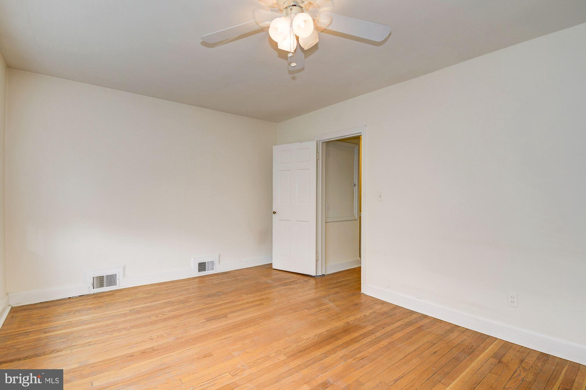 1218 Portner Road Alexandria, VA 22314 - Photo 12 of 31 a view of a room with wooden floor and a ceiling fan