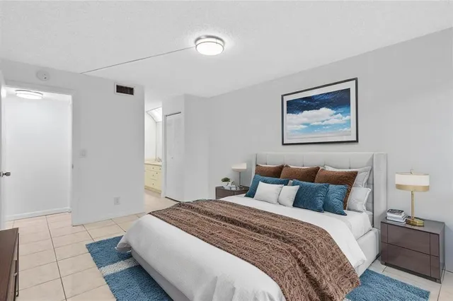 a bedroom with a bed and a painting on the wall