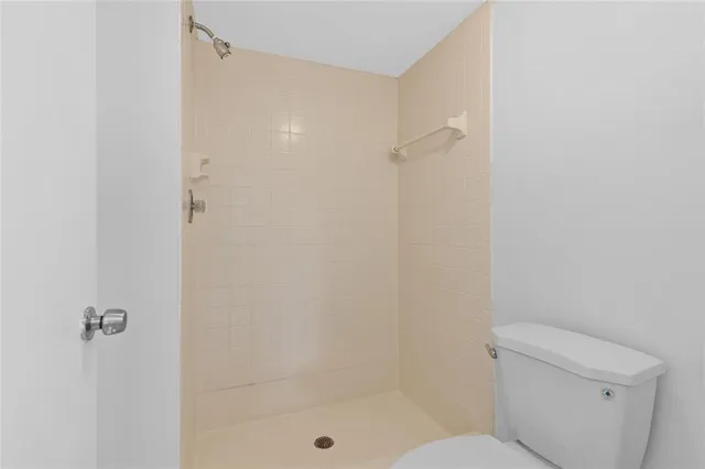 a bathroom with a shower and a toilet