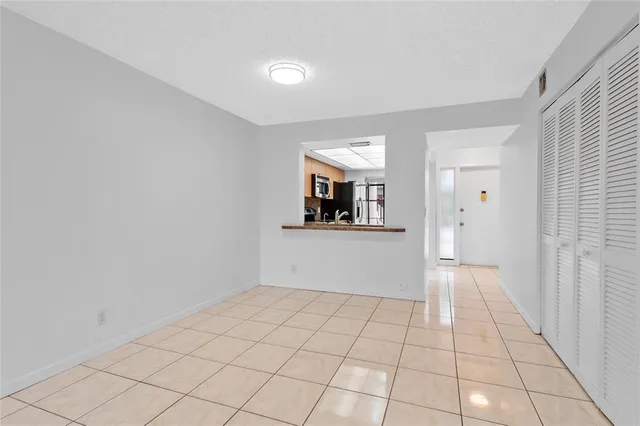 a view of a livingroom with an empty space and a window