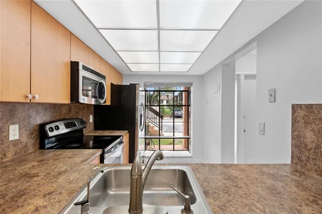 a view of a livingroom with workspace and a window