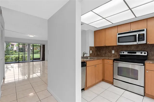 a kitchen with stainless steel appliances granite countertop a stove and a microwave