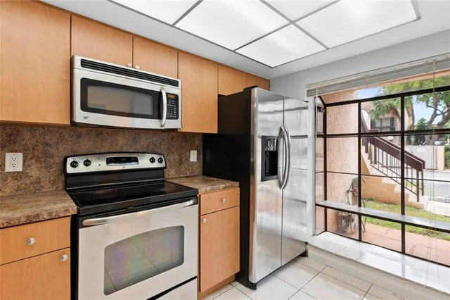 a kitchen with a stove microwave and refrigerator
