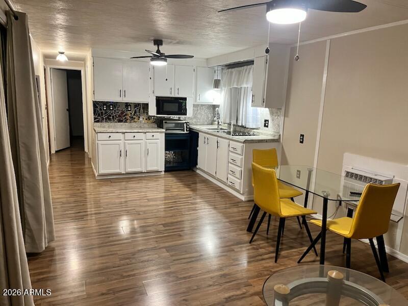 146 North Merrill Road, Unit 73 Apache Junction, AZ 85120 - Photo 19 of 19 a kitchen with a table chairs refrigerator and cabinets
