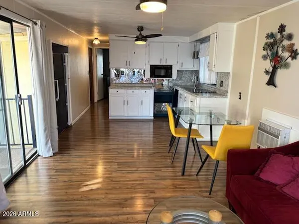 a living room with stainless steel appliances furniture or kitchen view and a window