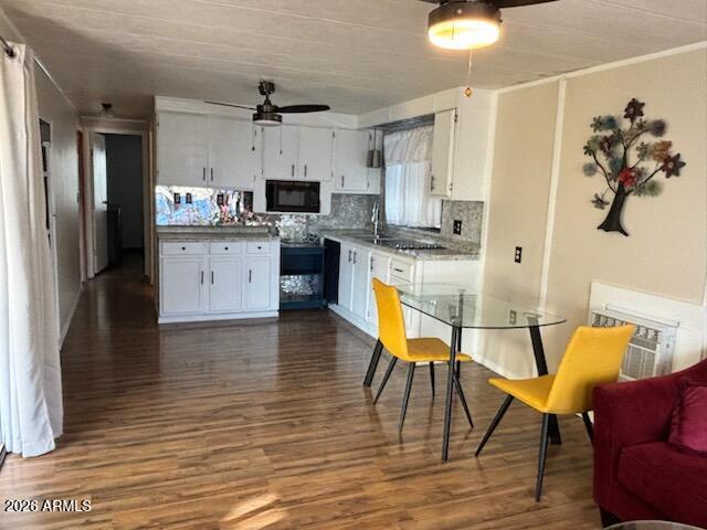 146 North Merrill Road, Unit 73 Apache Junction, AZ 85120 - Photo 4 of 19 a kitchen with stainless steel appliances granite countertop a refrigerator a stove top oven a sink dishwasher and white cabinets with wooden floor
