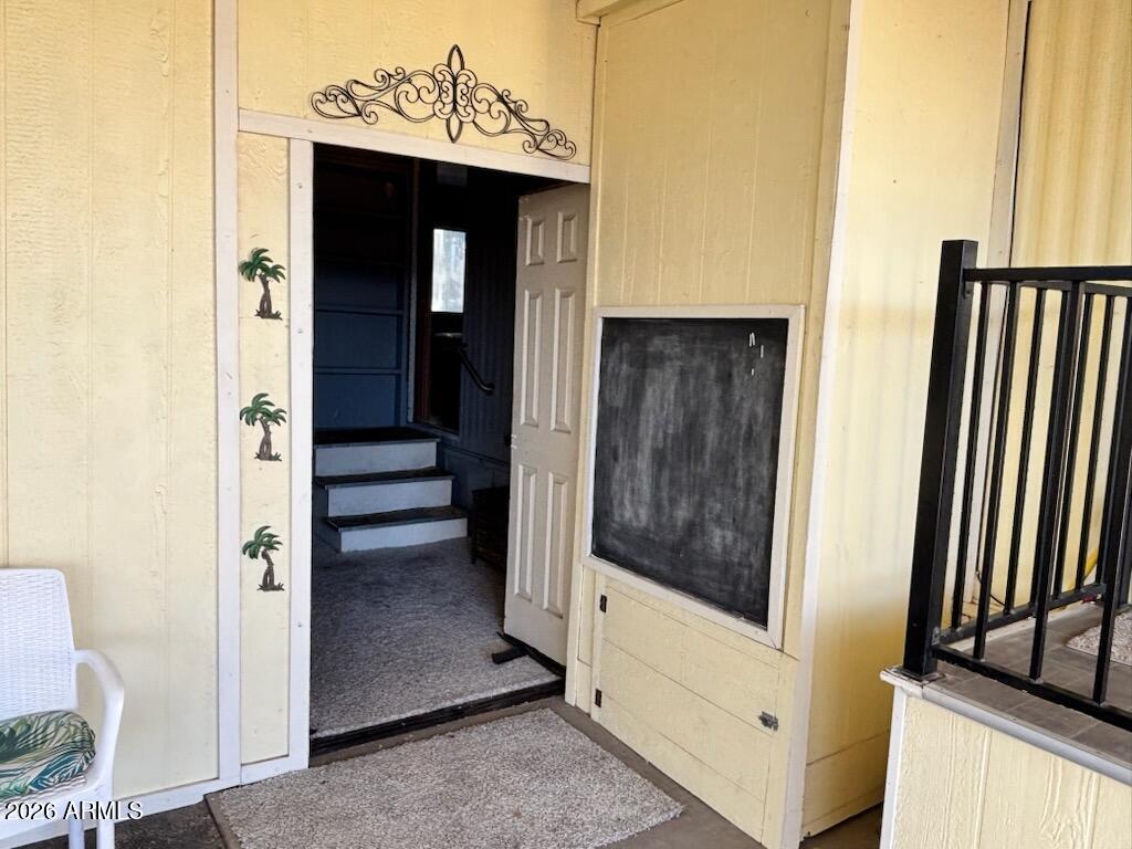 146 North Merrill Road, Unit 73 Apache Junction, AZ 85120 - Photo 5 of 19 a view of a hallway with wooden floor and staircase