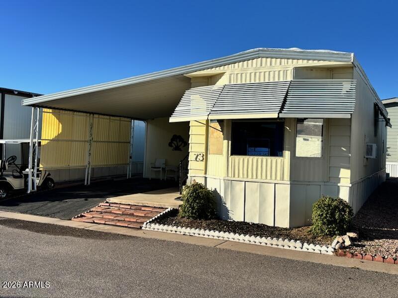 146 North Merrill Road, Unit 73 Apache Junction, AZ 85120 - Photo 6 of 19 a front view of a house with a garage