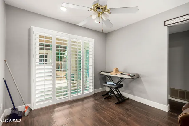 a view of a workspace with furniture and a window