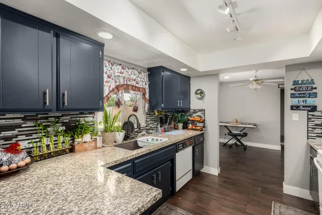 a kitchen with sink cabinets and wooden floor