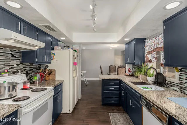 a kitchen with refrigerator and cabinets