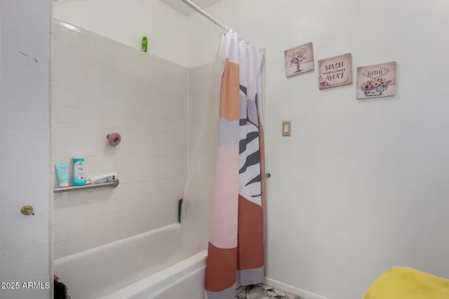 a bathroom with a bathtub and shower