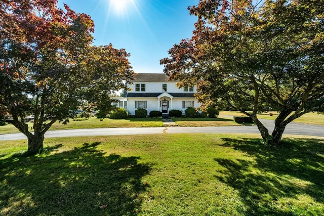 a house view with swimming pool in front of it