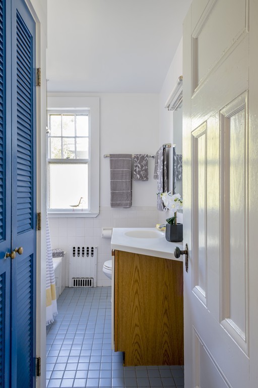 73-75 Upland Road Cambridge, MA 02140 - Photo 12 of 26 a spacious bathroom with a tub sink and mirror