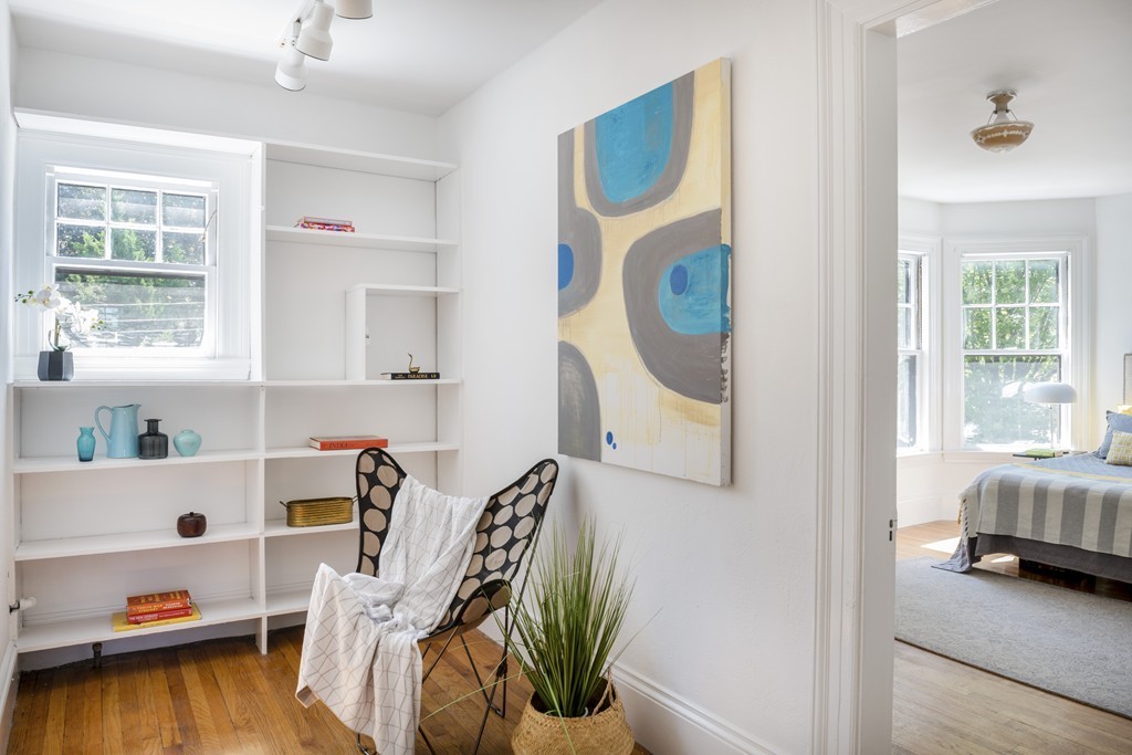 73-75 Upland Road Cambridge, MA 02140 - Photo 14 of 26 a view of a bedroom with baby bed and windows
