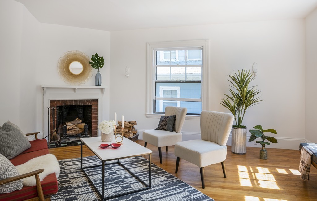 73-75 Upland Road Cambridge, MA 02140 - Photo 15 of 26 a living room with furniture and a fireplace