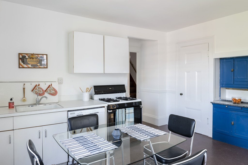 73-75 Upland Road Cambridge, MA 02140 - Photo 16 of 26 a kitchen with a stove and a chair