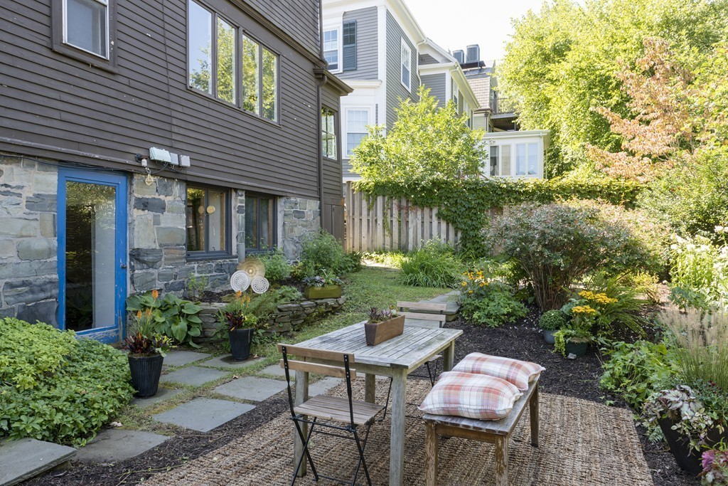 73-75 Upland Road Cambridge, MA 02140 - Photo 23 of 26 a backyard of a house with table and chairs
