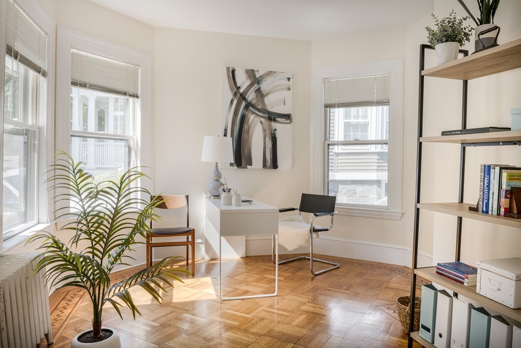73-75 Upland Road Cambridge, MA 02140 - Photo 3 of 26 a living room with furniture a window and a flat screen tv