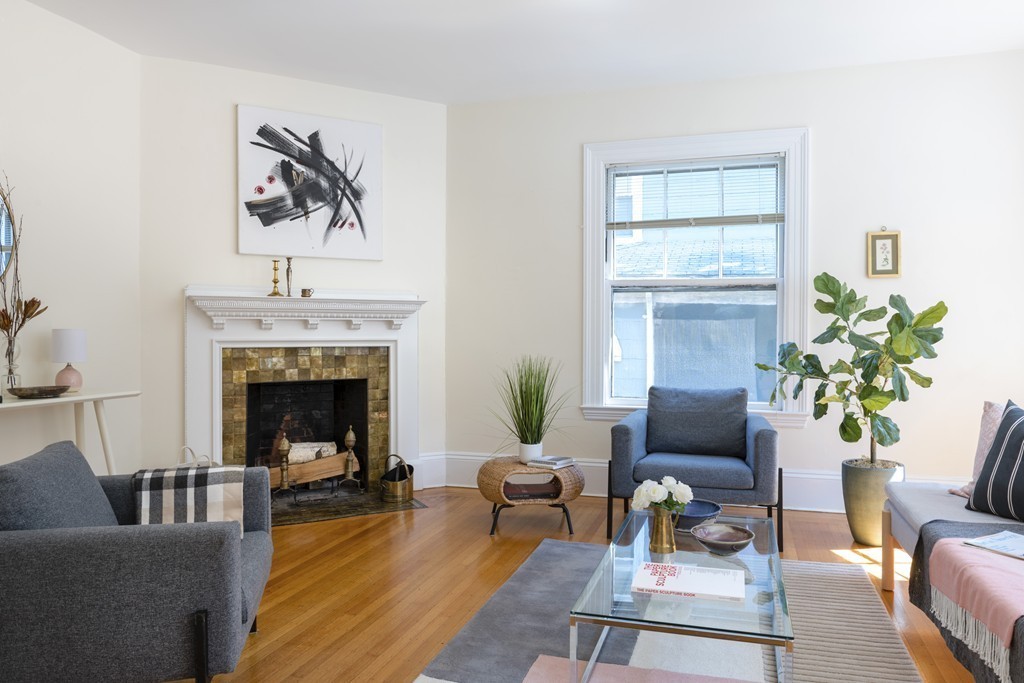 73-75 Upland Road Cambridge, MA 02140 - Photo 5 of 26 a living room with furniture and a fireplace